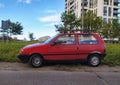 Classic small old compact city car red Fiat Uno 1.0 parked in a hot day in June, 2022 Royalty Free Stock Photo