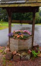 Old well used as a planter for flowers Royalty Free Stock Photo