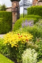 Well tended walled garden with wrought iron gate. Royalty Free Stock Photo