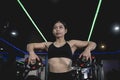 An well trained woman performs upright rows with 2 barbell plates. Variation on a common exercise for traps. Working out at the