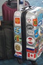 Well traveled suitcase, with international stickers, multi-colored