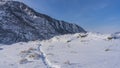 A well-trodden path winds through a valley