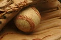 Well-used baseball nestled in a glove. Royalty Free Stock Photo