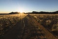 Well used, Dusty desert road to nowhere. Southern Namibia. Mountain scenery surrounding. S Royalty Free Stock Photo