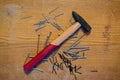 Hard Work Begins: Hammer and Scattered Nails on Wood Royalty Free Stock Photo