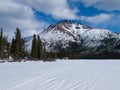 Well used winter trail on frozen mountain lake