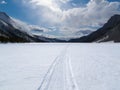 Well used winter trail on frozen mountain lake