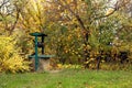 Well in the village, among yellow autumn leaves