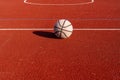 A well worn basketball ball on empty court