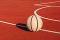 A well worn basketball ball on urban court