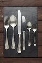 Well-worn cutlery on slate