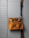 Craftsmans Tool Belt Hanging on a Pegboard Royalty Free Stock Photo