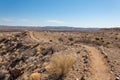 Well worn path along the top of a ridge in the New Mexico desert, bright blue sky