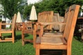 Well-worn wood furniture and umbrellas on manicured lawn