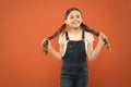 Wellbeing and health. Childhood concept. Fashion girl. Girl adorable kid stand over orange background. What is key to