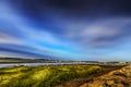 Wellfleet harbor at sunrise with rock and clouds