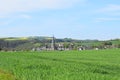 Welling, Germany - 05 09 2021: Village Welling in the valley behind green grain fields Royalty Free Stock Photo