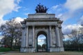 Wellington Arch or Constitution Arch is a triumphal arch located to the south of Hyde Park in London. Dramatic cloudy Royalty Free Stock Photo