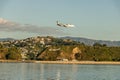 Wellington Sign At Sunset With Plane Landing Royalty Free Stock Photo