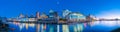 Wellington skyline at night from wharf with city lights, signs and reflections on harbor Royalty Free Stock Photo