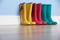 Wellingtons lines up against wall Royalty Free Stock Photo