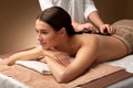 Beautiful woman having hot stone massage at spa Royalty Free Stock Photo