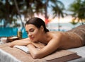 woman lying with sea salt on skin at spa Royalty Free Stock Photo