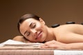 Smiling woman having hot stone massage at spa Royalty Free Stock Photo