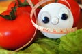 Wellness centimeter with eyes look on tomato and salad