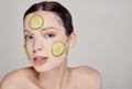 Close up gentle sophisticated mysterious girl in a moisturizing mask with a fresh cucumber on the face Royalty Free Stock Photo
