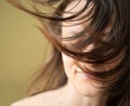 Wellness, cosmetics and hairstyle. Portrait of beautiful woman model with flying straight hair whicking across her face Royalty Free Stock Photo