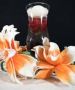 Wellness, glass with floating rose on sand Royalty Free Stock Photo