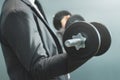 Wellness, healthy concepts. Businessman lifting dumbbell at office. Royalty Free Stock Photo