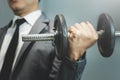 Wellness, healthy concepts. Businessman lifting dumbbell at office. Royalty Free Stock Photo