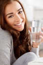 Wellness, hydration and water with young woman living a balance diet lifestyle, drinking refreshing drink at home