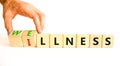 Wellness or illness symbol. Concept words Wellness and Illness on wooden cubes. Doctor hand. Beautiful white table white Royalty Free Stock Photo