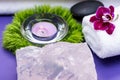 Wellness Relax concept with Spa elements. Basalt Stones, Lavender Tea Light Candle, Dianthus Flowers, Orchid and Rose Quartz Royalty Free Stock Photo