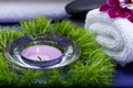 Wellness Relax concept with Spa elements. White Towels, Basalt Stones, Orchid, Lavender Tea Light Candle and Dianthus Flowers Royalty Free Stock Photo