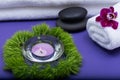 Wellness Relax concept with Spa elements. White Towels, Basalt Stones, Orchid, Lavender Tea Light Candle and Dianthus Flowers Royalty Free Stock Photo