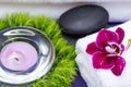 Wellness Relax concept with Spa elements. White Towels, Basalt Stones, Orchid, Lavender Tea Light Candle and Dianthus Flowers Royalty Free Stock Photo