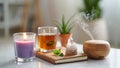 Wellness and self care scene featuring an aromatherapy diffuser emitting vapor, a burning candle, a refreshing tea, and healing Royalty Free Stock Photo