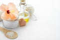 Wellness setting. Sea salt in glass, soap, towel, olive oil and flowers Royalty Free Stock Photo