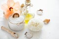 Wellness setting. Sea salt in glass, soap, towel, olive oil and flowers Royalty Free Stock Photo