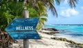 Wellness sign board arrow on beach with sunshine background Royalty Free Stock Photo