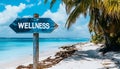 Wellness sign board arrow on beach with sunshine background Royalty Free Stock Photo