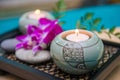 Wellness and spa concept with candles and orchid Royalty Free Stock Photo