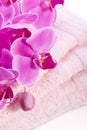 Wellness towel with pink orchid flower Royalty Free Stock Photo