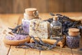 lavender oil and salt in glass bottle on background of dry lavender flowers. Natural cosmetic Royalty Free Stock Photo