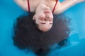 Wellness - young woman floating in Spa or swimming pool, she is very relaxed. Top view. Royalty Free Stock Photo