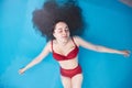 Wellness - young woman floating in Spa or swimming pool, she is very relaxed Royalty Free Stock Photo